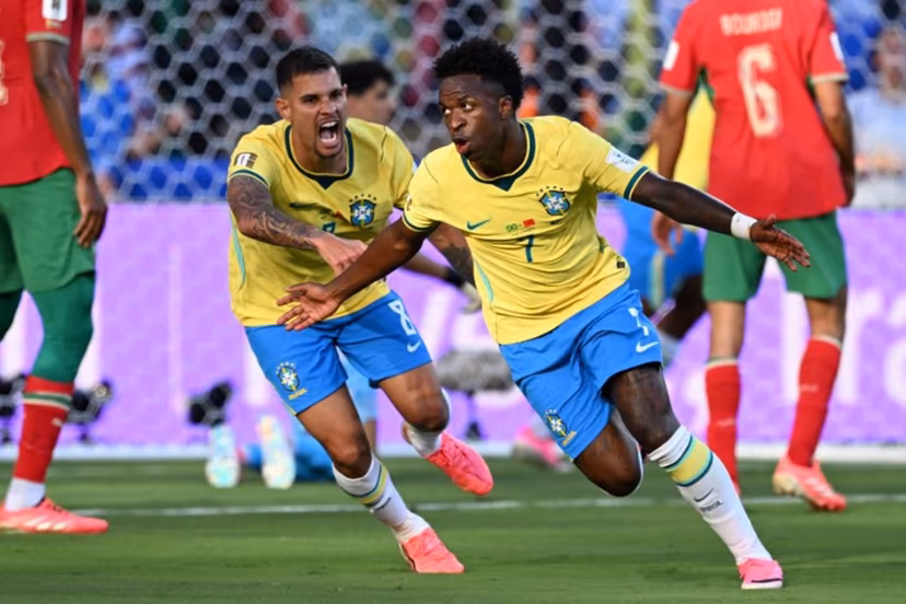 Brazil's forward #07 Vinicius Junior (R) celebrates scoring his team's first goal during the 2026 World Cup Group C football match between Brazil and Morocco at the New York/New Jersey Stadium in East Rutherford on June 13, 2026. Jewel SAMAD / AFP