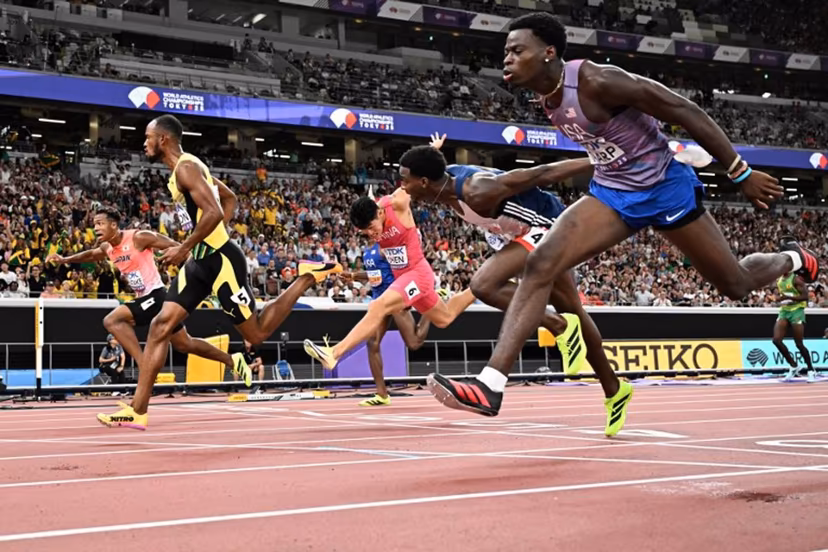 Athletes including US' athlete Ja'Kobe Tharp (R) and Jamaica's athlete Orlando Bennett (2nd L) cross the finish line in the men's 110m hurdles heats during the World Athletics Championships in Tokyo on September 15, 2025. Jewel SAMAD / AFP