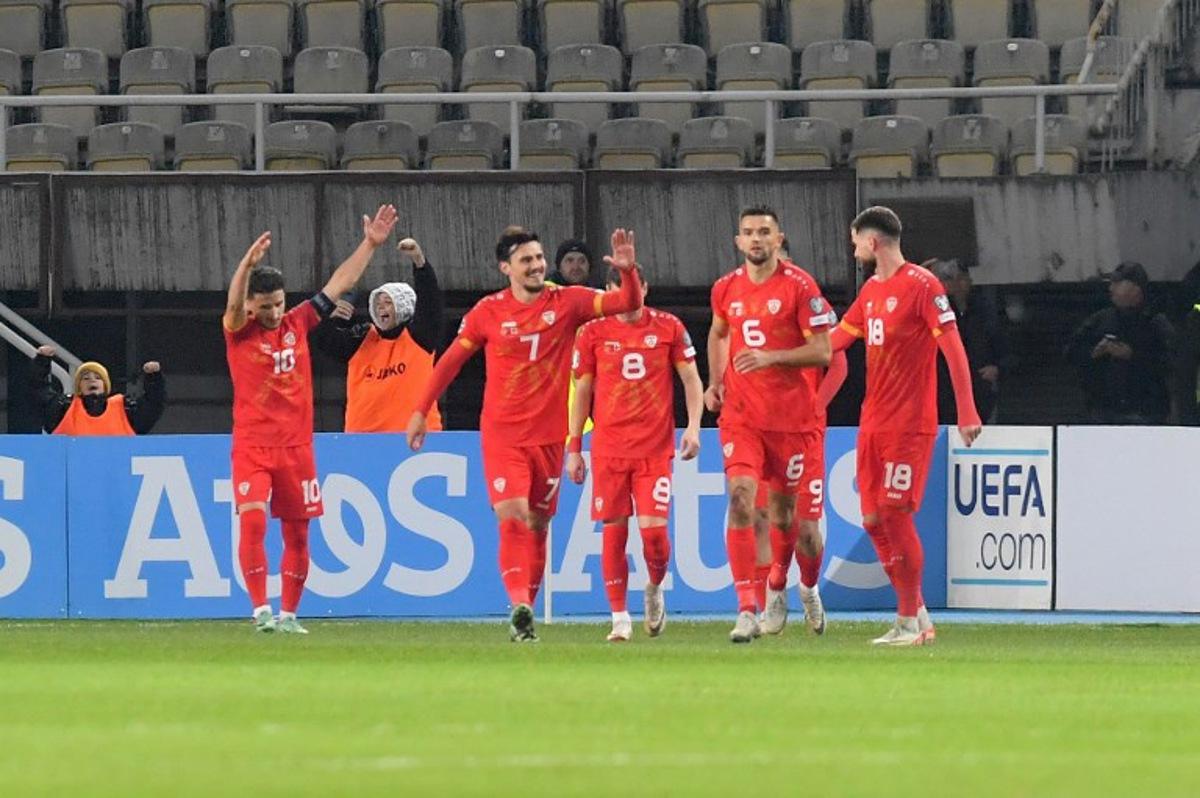 North Macedonia's midfielder #10 Enis Bardhi (L) celebrates with his teammates after scoring the opening goal during the UEFA Euro 2024 group C qualification football match between North Macedonia and England at National Arena "Todor Proeski" in Skopje on November 20, 2023. Robert ATANASOVSKI / AFP