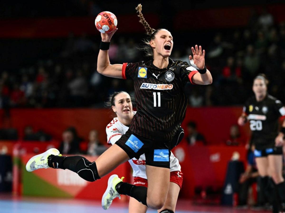 Germany's left back #11 Xenia Smits passes the ball during the European Women's EHF EURO 2024 Handball Championship Group II main round match between Switzerland and Germany in Vienna, Austria, on December 5, 2024. Joe Klamar / AFP