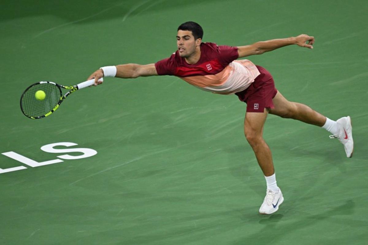 Spain's Carlos Alcaraz hits a return during his men's singles quarter-final tennis match against Argentina's Francisco Cerundolo at the BNP Paribas Open at the Indian Wells Tennis Garden in Indian Wells, California, on March 13, 2025. Patrick T. Fallon / AFP