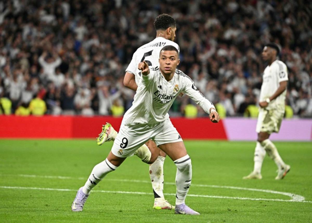 Real Madrid's French forward #09 Kylian Mbappe celebrates after Real Madrid's English midfielder #05 Jude Bellingham scored his team's second goal during the Spanish Copa del Rey (King's Cup) semi-final second leg football match between Real Madrid CF and Real Sociedad at the Santiago Bernabeu stadium in Madrid on April 1, 2025. JAVIER SORIANO / AFP
