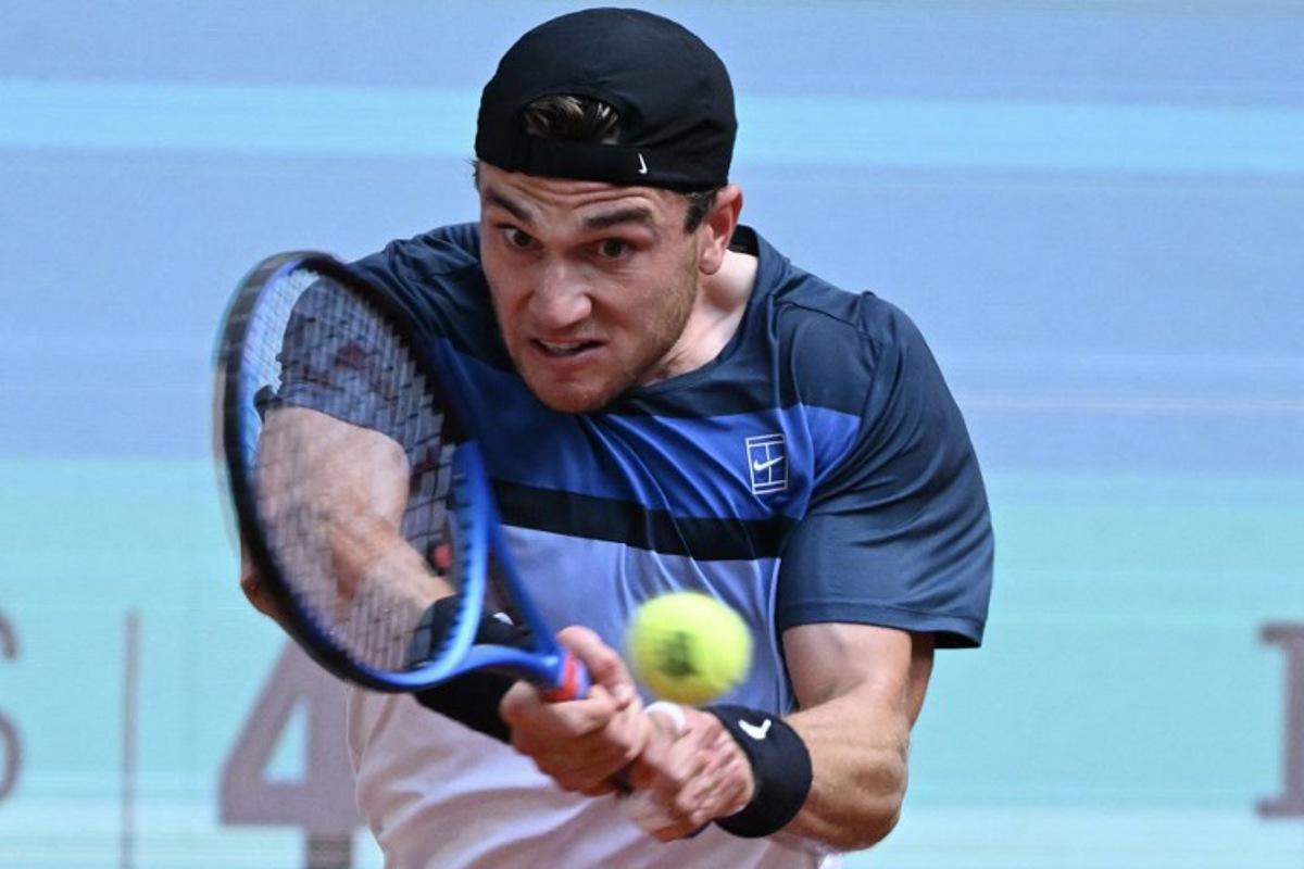 Great Britain's Jack Draper returns a backhand to Italy's Matteo Arnaldi during their 2025 ATP Tour Madrid Open tennis tournament quarter-final singles match at the Caja Magica in Madrid, on May 1, 2025. JAVIER SORIANO / AFP