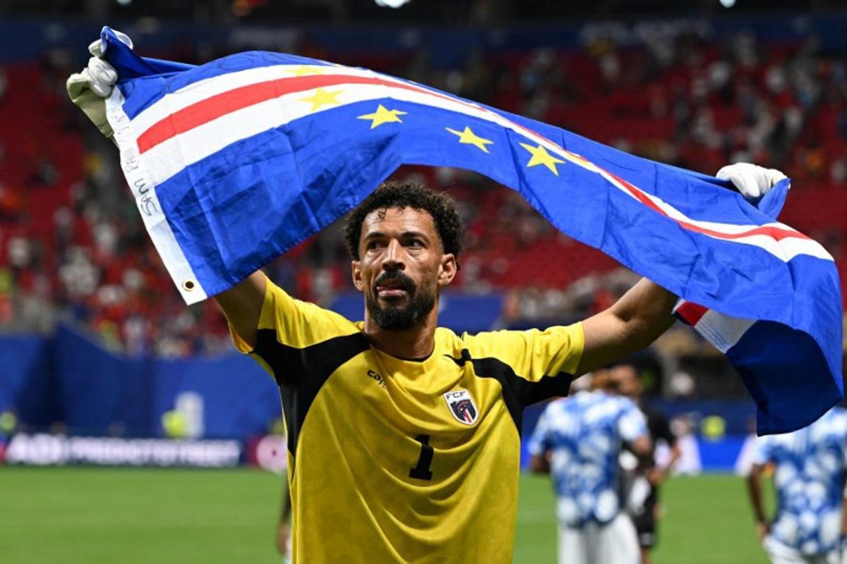 Cape Verde's goalkeeper #01 Vozinha celebrates with his national flag at the end of the 2026 World Cup Group H football match between Spain and Cape Verde at the Atlanta Stadium in Atlanta on June 15, 2026. ROBERTO SCHMIDT / AFP