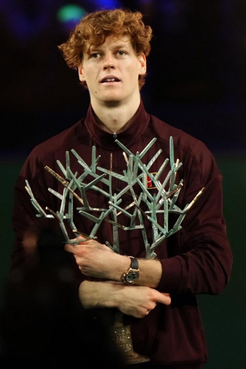 Italy's Jannik Sinner celebrates with the trophy after winning the men's singles final match of the Paris ATP Masters 1000 tennis tournament against Canada's Felix Auger-Aliassime at the Paris La Défense Arena in Nanterre, on the outskirts of Paris, on November 2, 2025. Dimitar DILKOFF / AFP