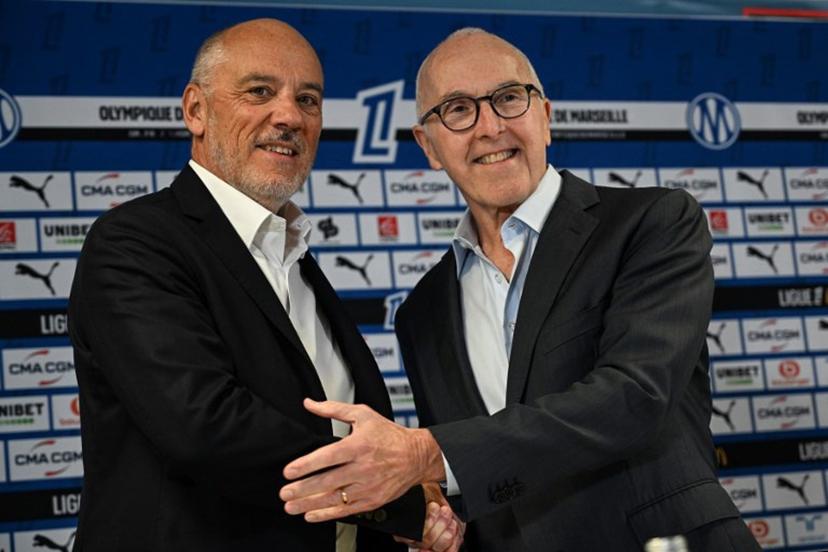 French fooball club Olympique de Marseille (OM) US owner Frank McCourt (R) shakes hand with the club's new president Stephane Richard (L) at the start of a press conference at the Velodrome Stadium in Marseille, southeastern France, on April 10, 2026. Gabriel BOUYS / AFP