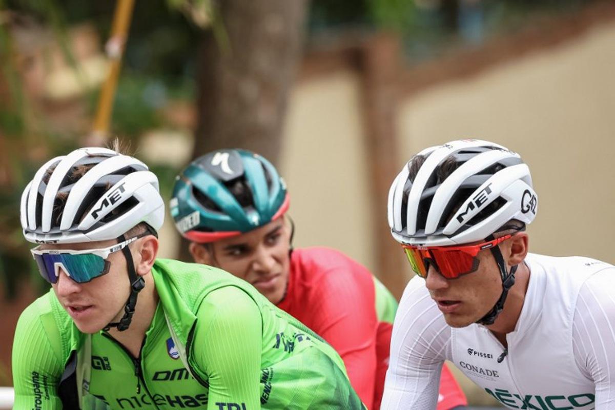 Slovenian rider Tadej Pogacar (L) and Mexican rider Isaac del Toro (R) cycle during a training session during the UCI 2025 Road World Championships, in Kigali, on September 24, 2025. Anne-Christine POUJOULAT / AFP