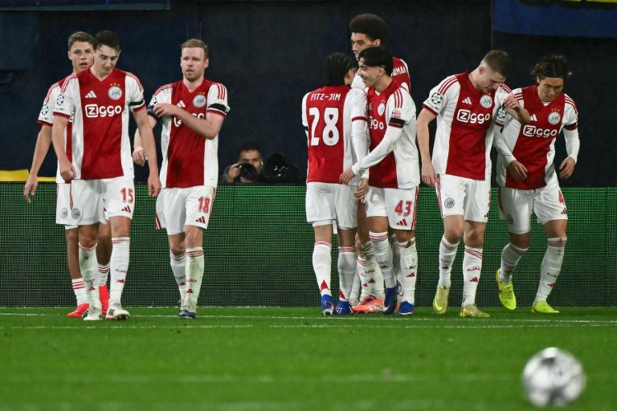 Ajax's Norwegian forward #17 Oliver Edvardsen (behind) celebrates with teammates after scoring his team's second goal during the UEFA Champions League league phase day 7 football match between Villarreal CF and Ajax at La Ceramica Stadium in Vila-real on January 20, 2026. JOSE JORDAN / AFP