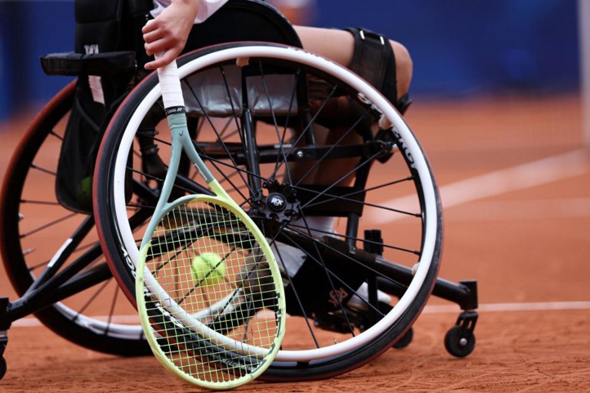 China's Luoyao Guo holds her racket as she competes during the quarter-finals of the women's wheelchair tennis match against Netherlands' Diede De Groot on the Suzanne-Lenglen Court at the Roland-Garros Stadium, during the Paris 2024 Paralympic Games on September 3, 2024. ALAIN JOCARD / AFP