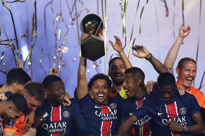 Paris Saint-Germain's Brazilian defender #05 Marquinhos (C) lifts the trophy as PSG celebrate their championship title following the French L1 football match between Paris Saint-Germain (PSG) and AJ Auxerre at The Parc des Princes Stadium in Paris on May 17, 2025. FRANCK FIFE / AFP