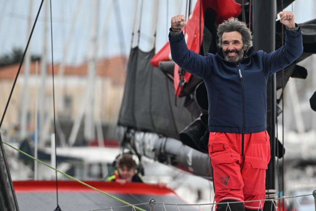 Belgian skipper Denis Van Weynbergh celebrates from his Imoca monohull D Ieteren Group upon his arrival at Les Sables-d'Olonne at the end of the 10th edition of the Vendee Globe around the world monohull solo sailing race in Les Sables-d'Olonne, western France, on March 8, 2025. Sebastien Salom-Gomis / AFP