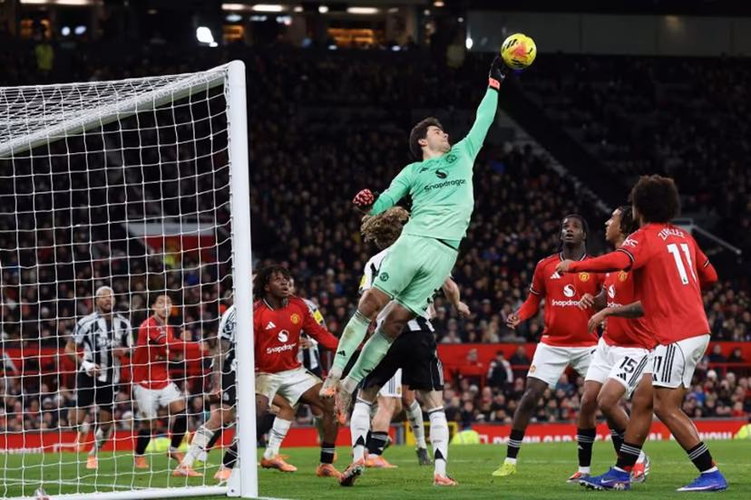 Manchester United's Belgian goalkeeper #31 Senne Lammens fails to push the ball away but is fouled during the English Premier League football match between Manchester United and Newcastle United at Old Trafford in Manchester, north west England, on December 26, 2025. Darren Staples / AFP