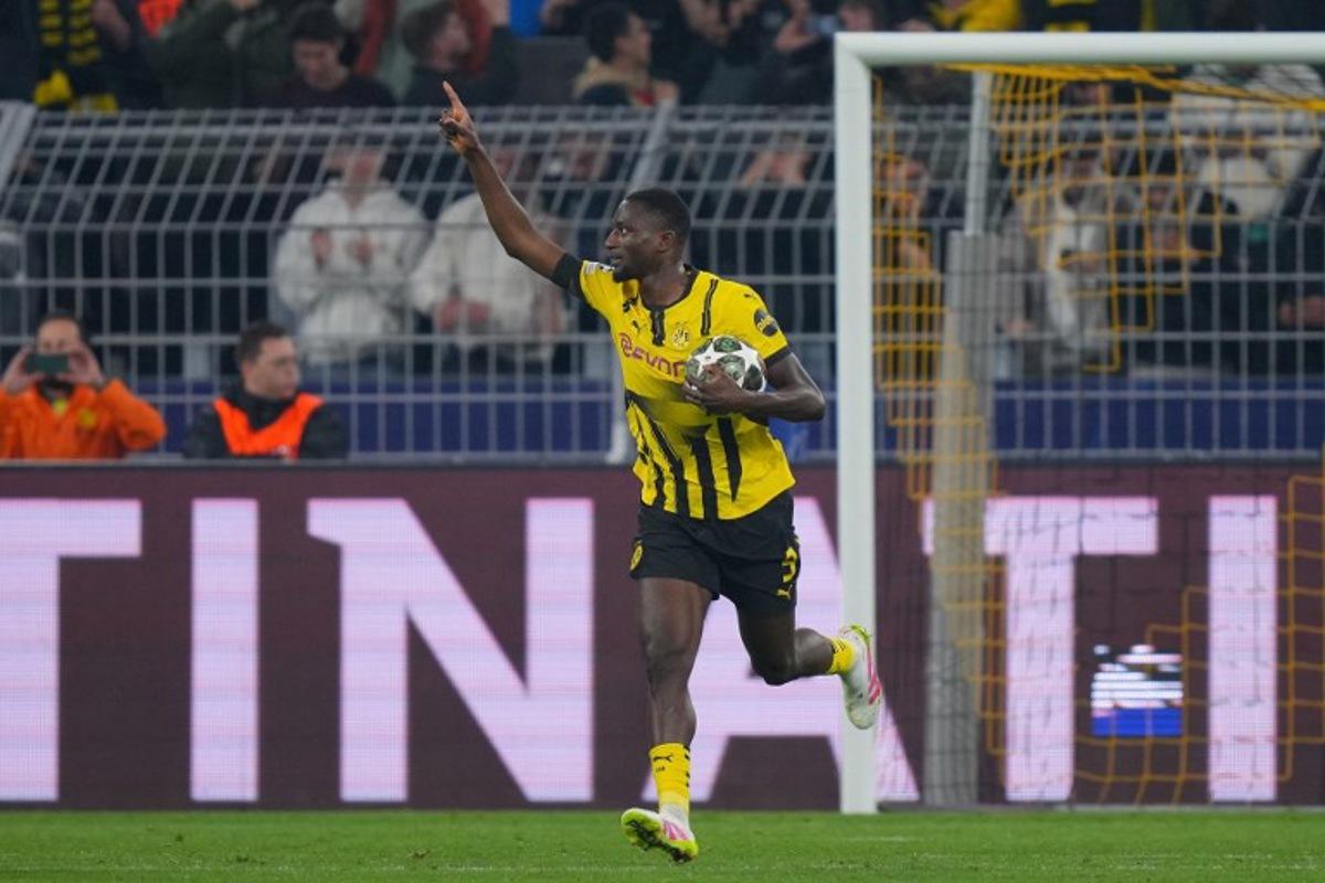Dortmund's Guinean forward #09 Serhou Guirassy celebrates scoring the opening goal from the penalty spot during the UEFA Champions League quarter-final second leg football match between BVB Borussia Dortmund and FC Barcelona in Dortmund, western Germany on April 15, 2025. Pau BARRENA / AFP