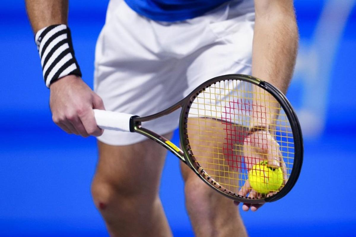 A tennis players holds racquet and ball to play a serve to his opponent during a match of the Erste Bank Open tennis tournament in Vienna on October 26, 2023. Eva MANHART / APA / AFP