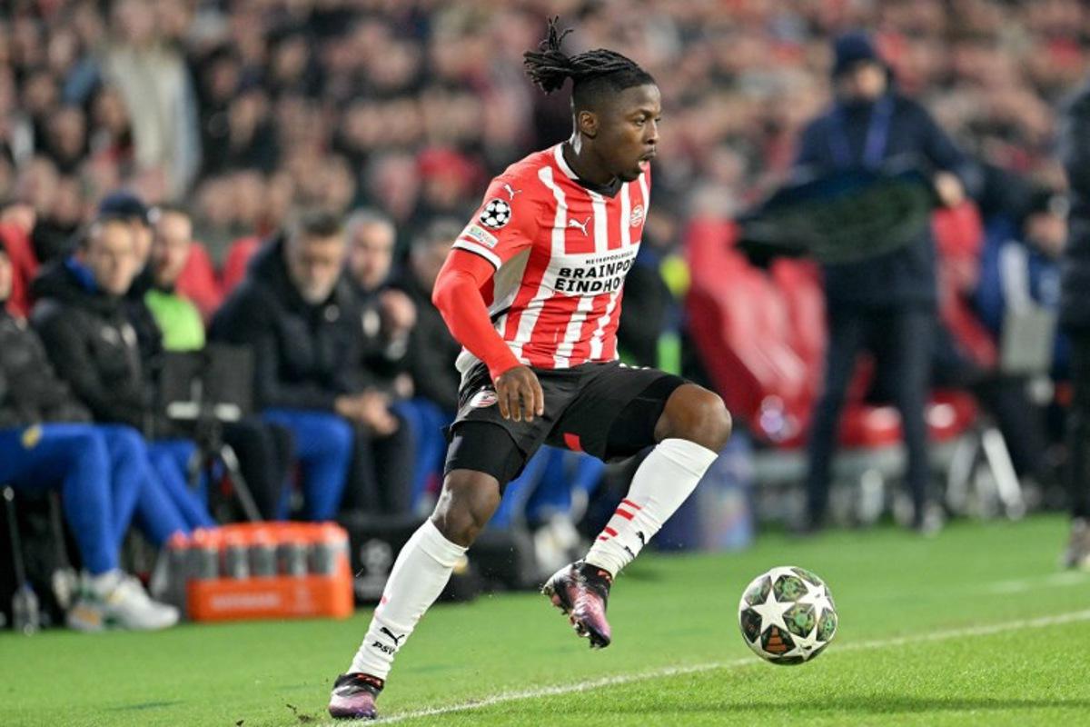 PSV Eindhoven's Belgian forward #11 Johan Bakayoko drives the ball during the UEFA Champions League knockout phase play-off 2nd leg football match between PSV Eindhoven and Juventus at the Philips Stadion in Eindhoven on February 19, 2025. NICOLAS TUCAT / AFP